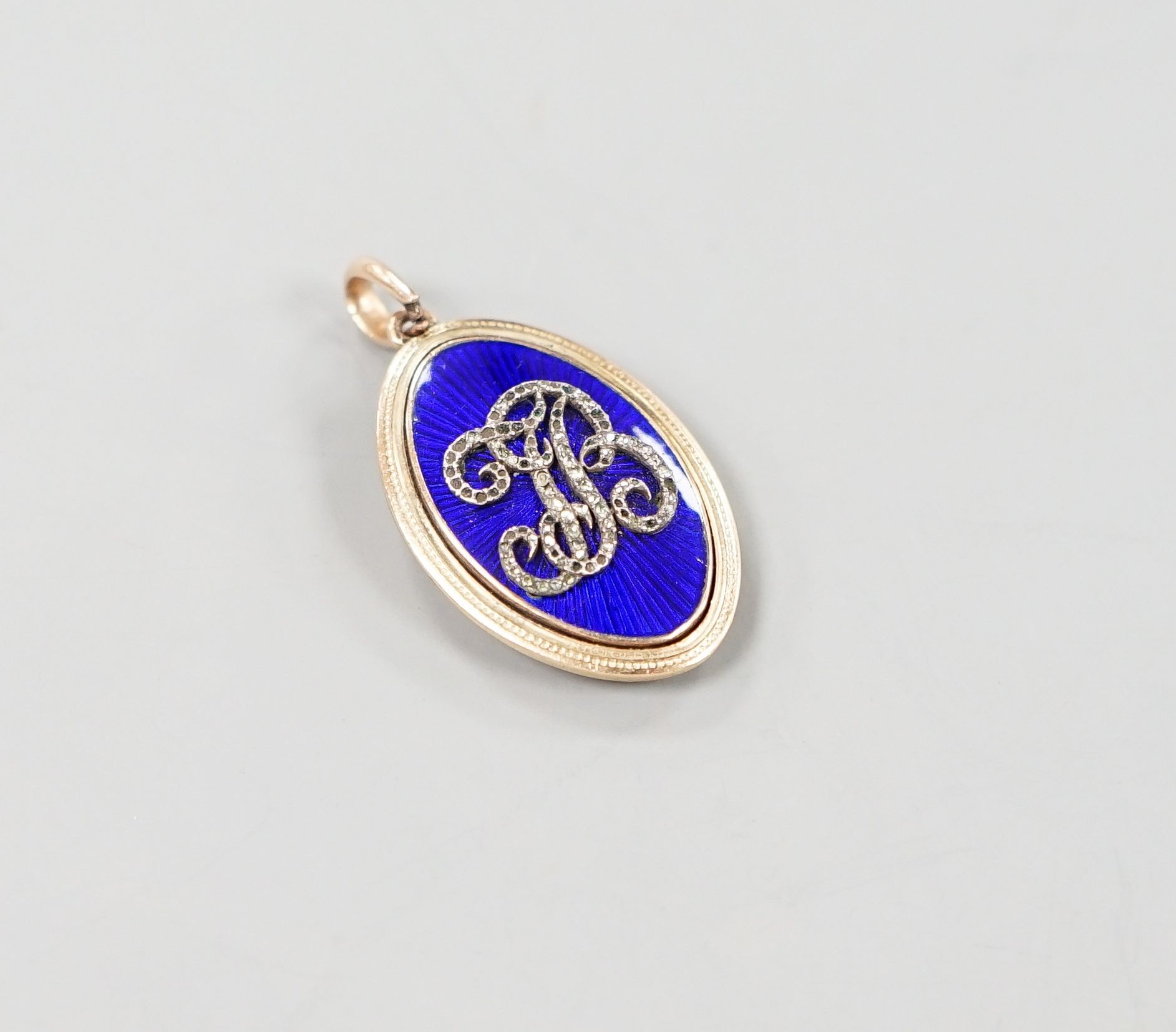 An early 19th century yellow metal, blue enamel and rose cut diamond chip set navette shaped 'monogram' pendant, 30mm, gross weight 5.8 grams.